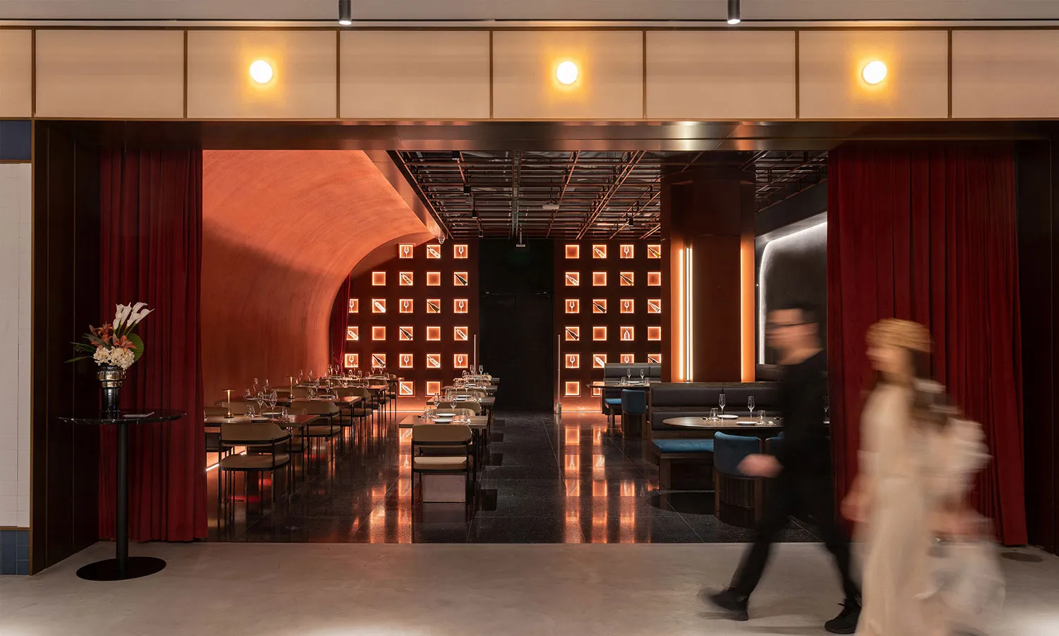 A modern restaurant interior with metallic textured walls