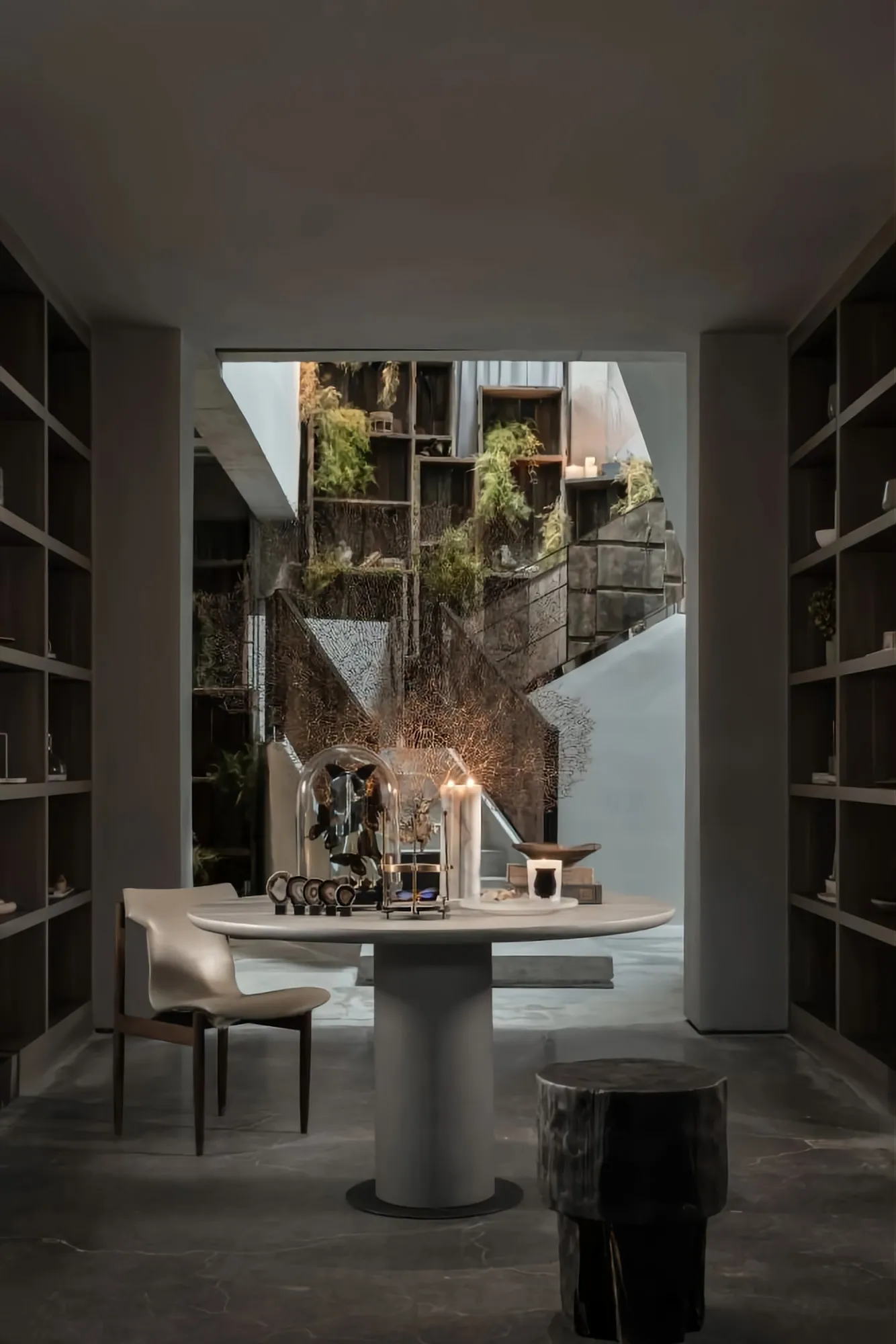 A modern living room with concrete walls and furniture, creating a minimalist and industrial aesthetic.