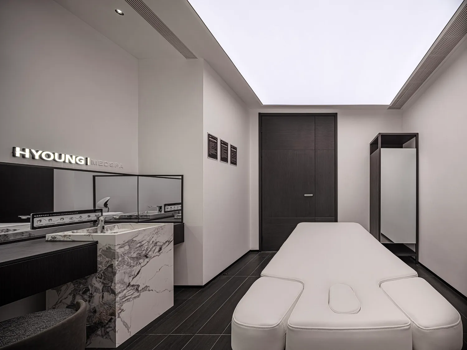 Modern interior design of a medi-spa featuring marble countertops and minimalist furniture.