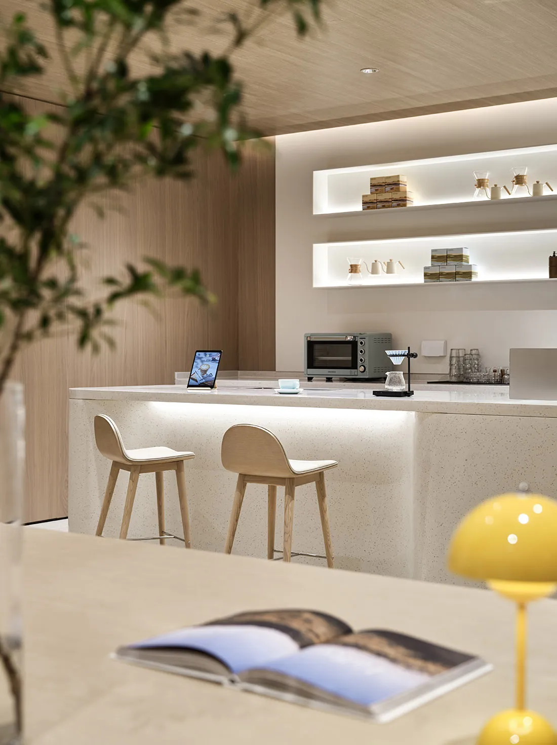 Modern design coffee shop featuring a terrazzo countertop and stools.