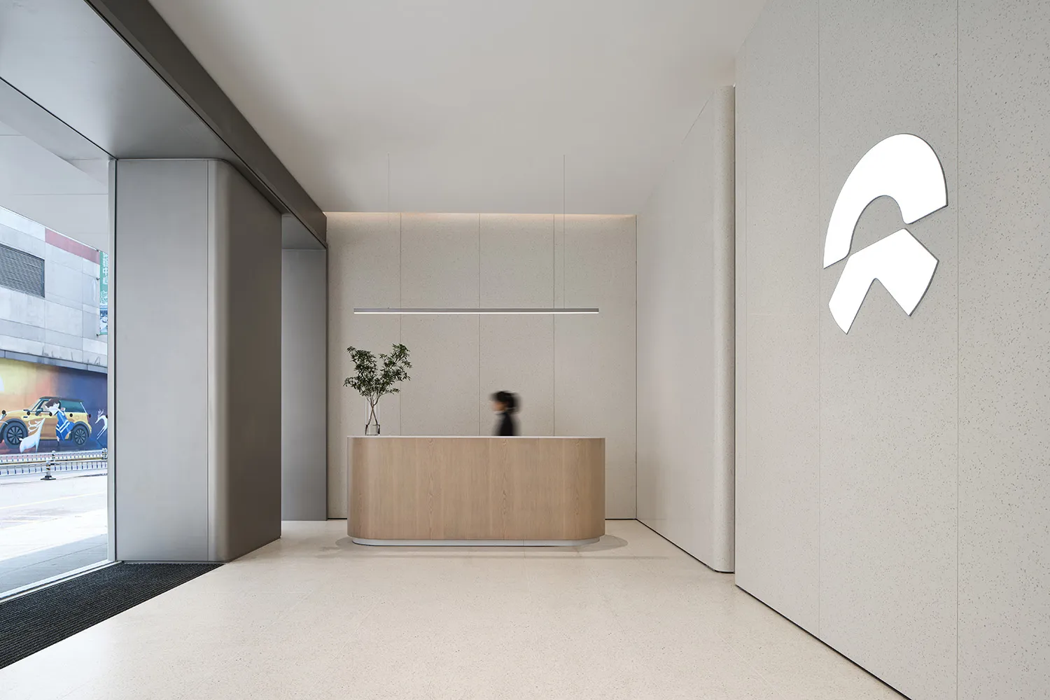 Modern office reception desk with wood and concrete materials.