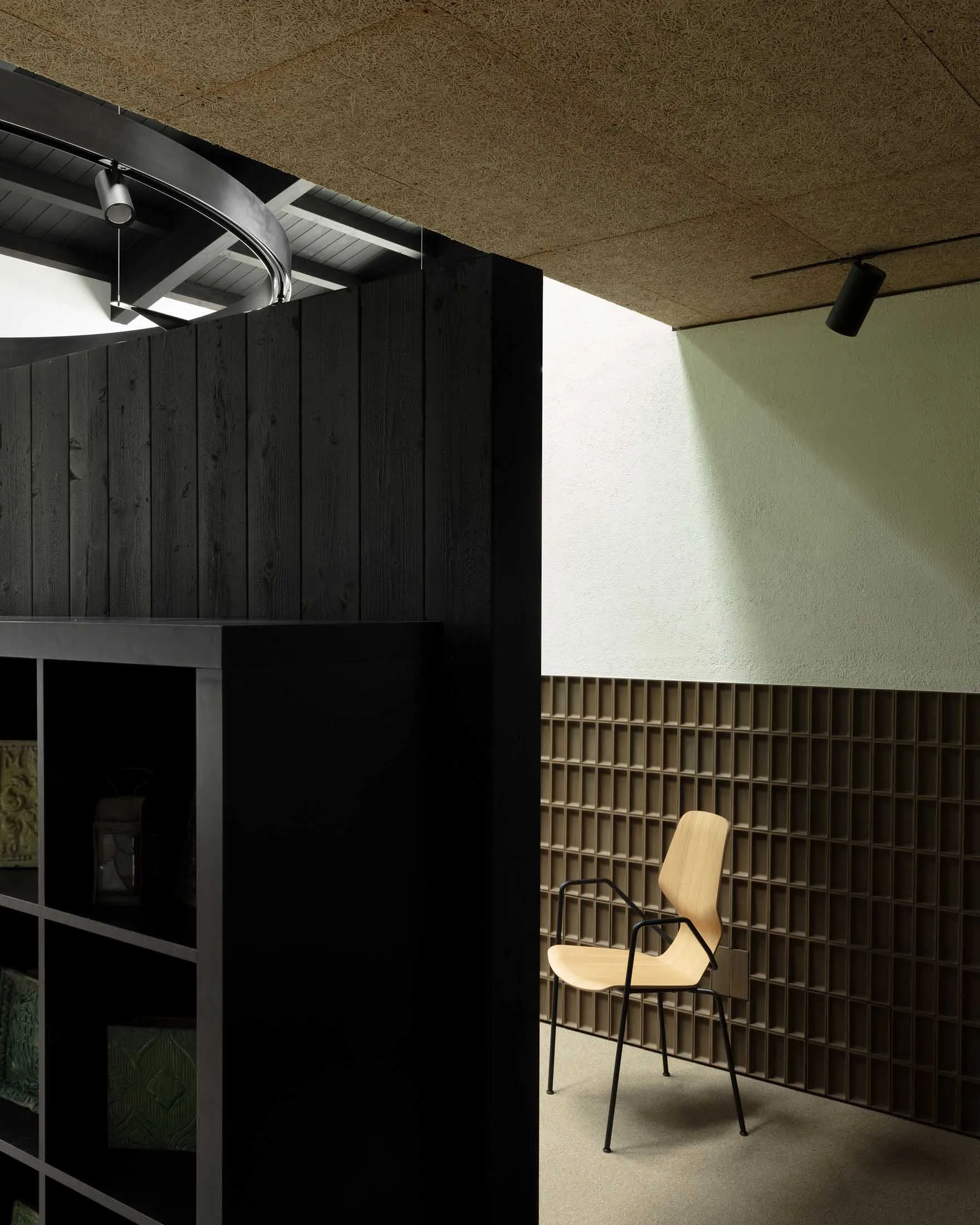 A minimalist office space featuring wooden furniture and metal accents.