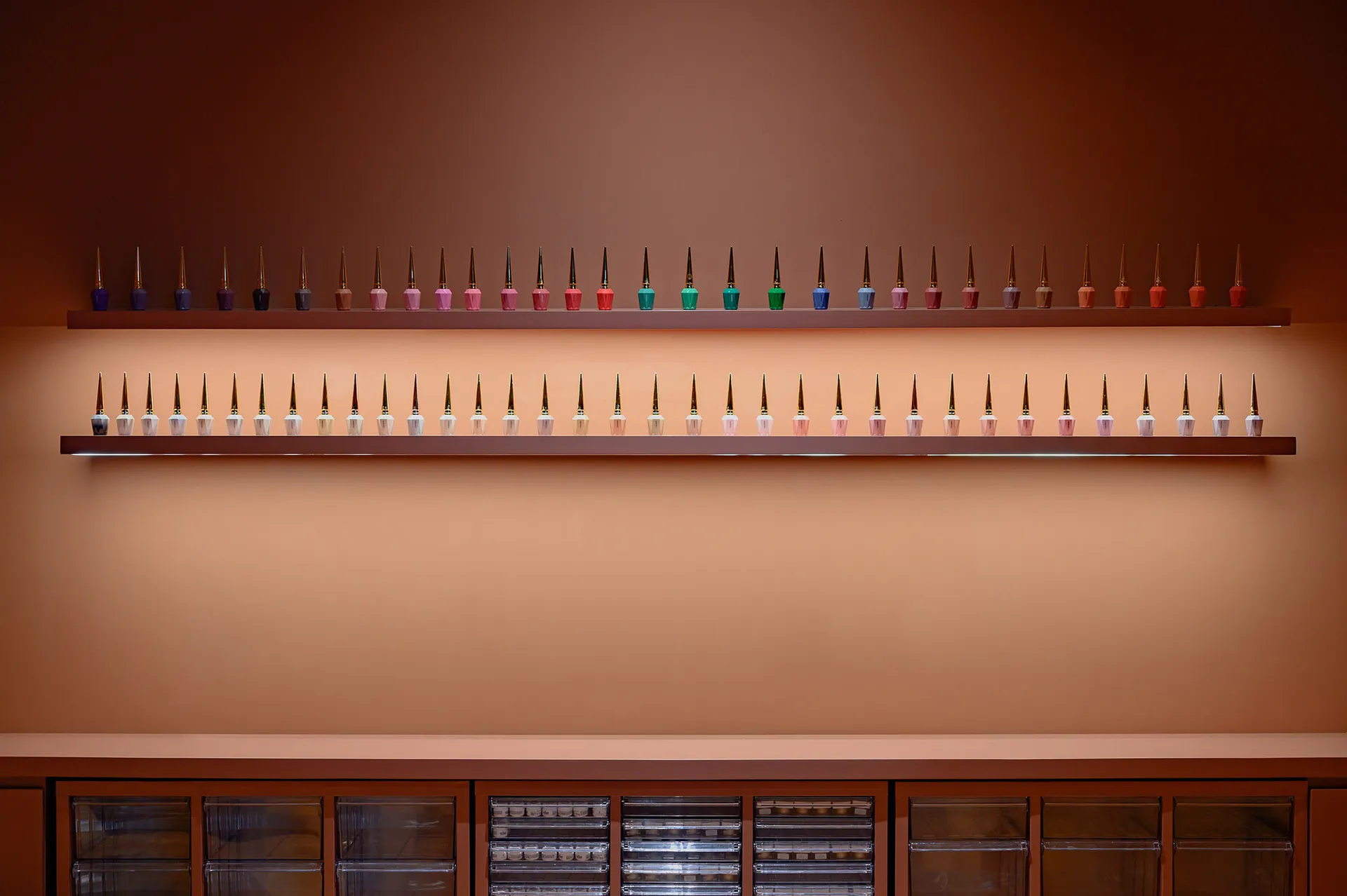 Modern retail display shelves with multiple bottles of nail polish arranged neatly on floating shelves.