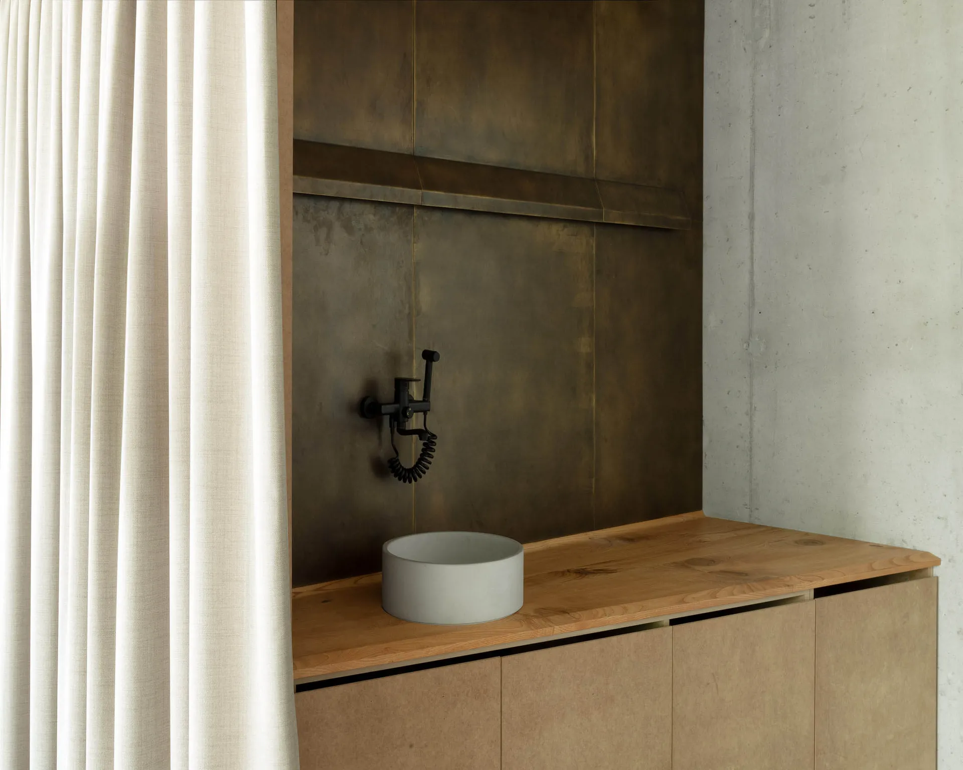 Modern minimalist bathroom featuring concrete sink and wooden vanity.