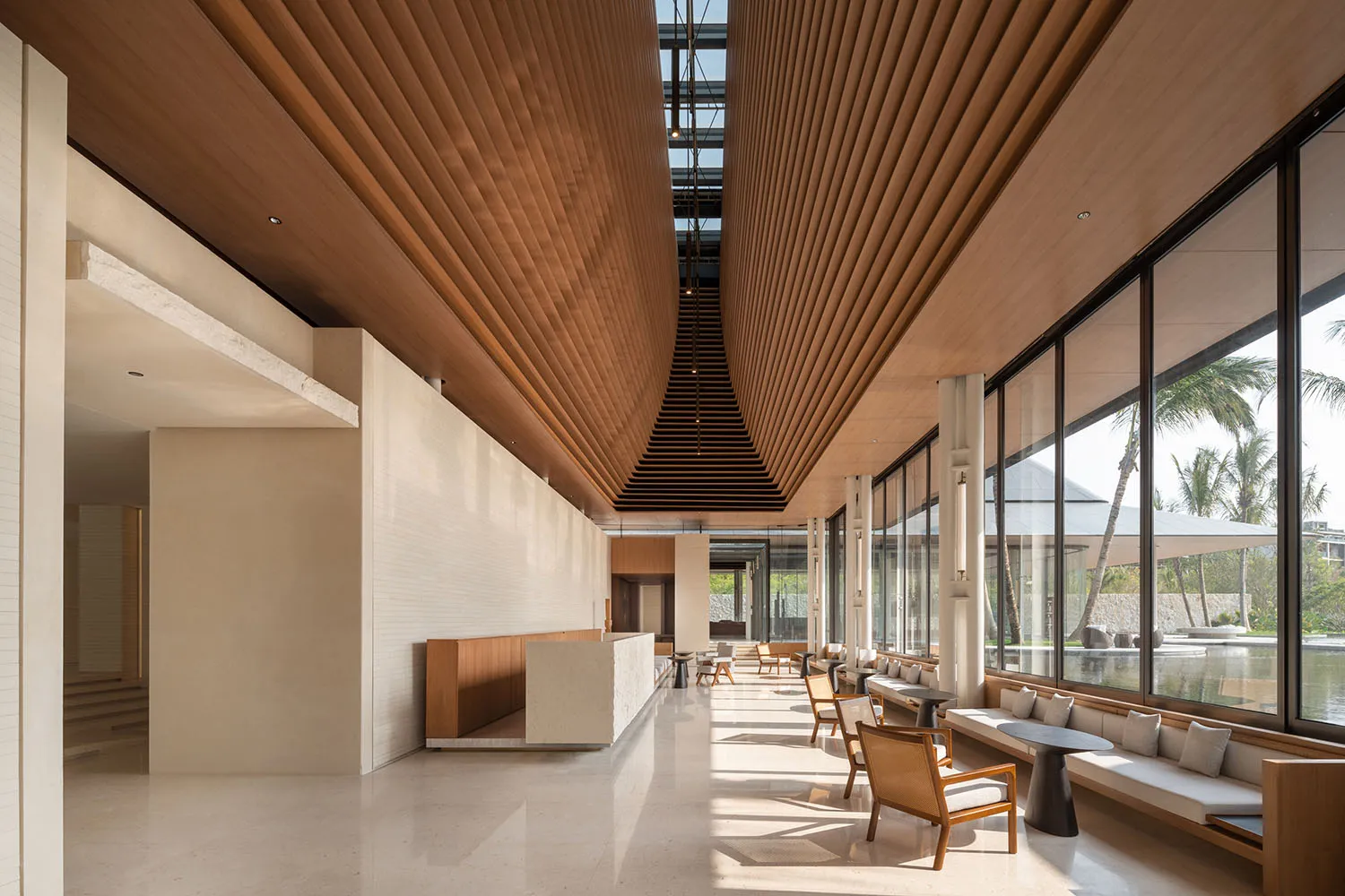 Modern hotel lobby featuring wood-tile ceiling and marble floor