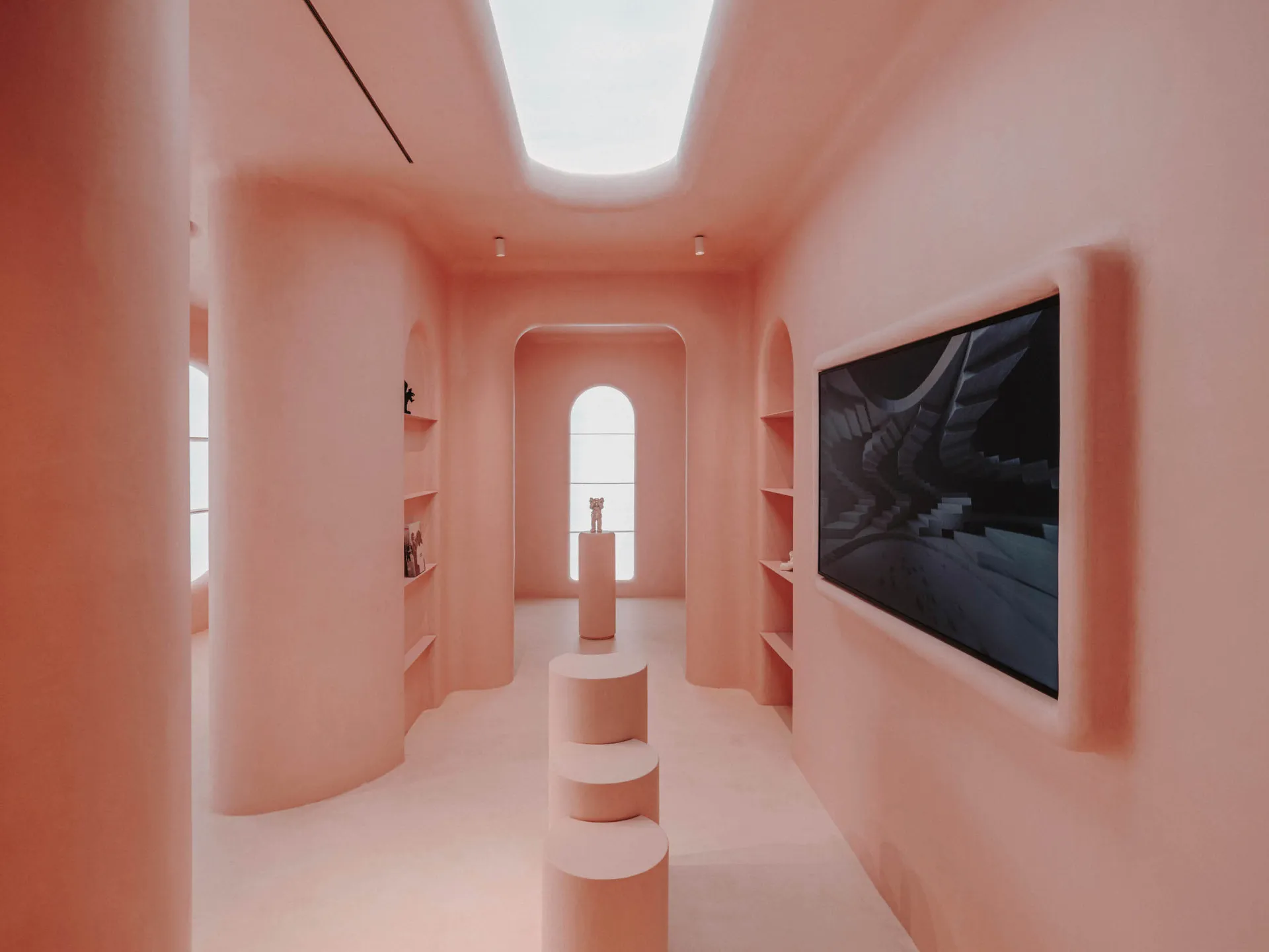A minimalist retail space with concrete walls and floors, featuring a geometric design and a skylight.