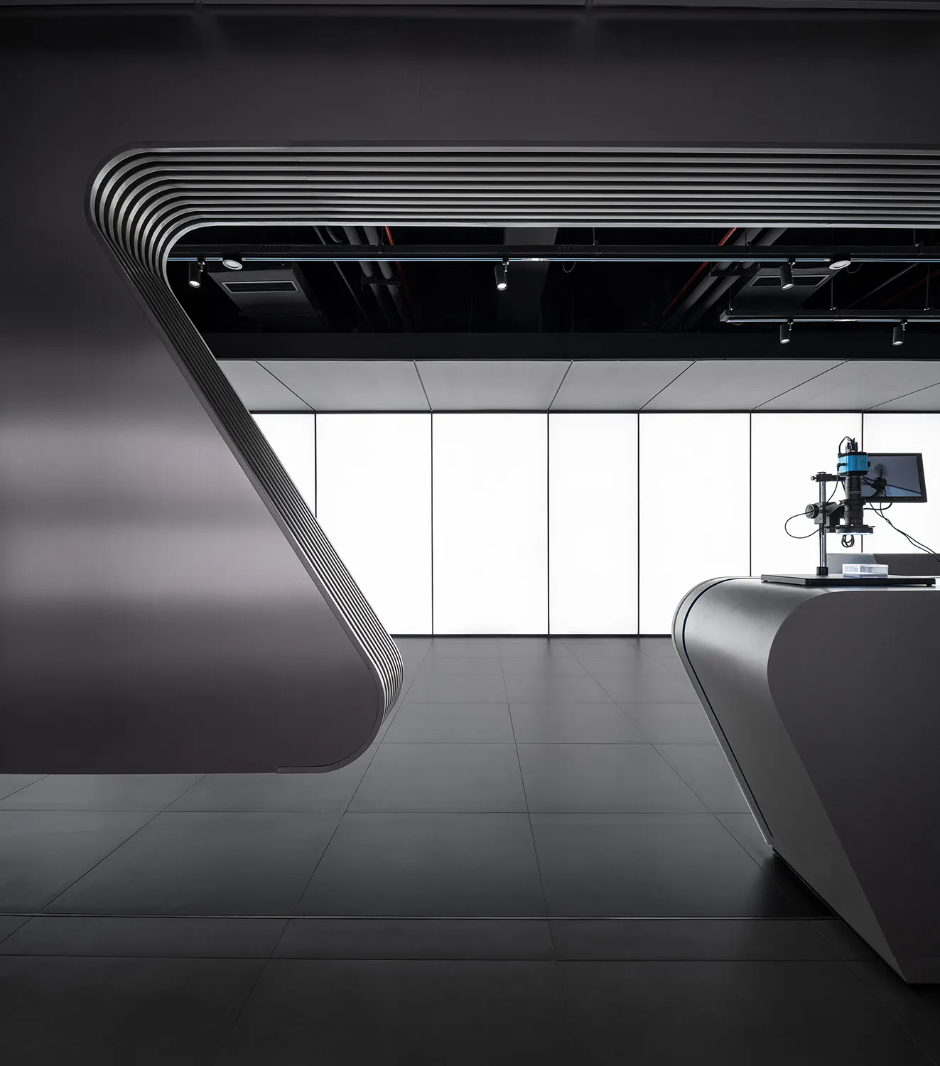 A modern office space with black interiors and a sleek, minimalist design.