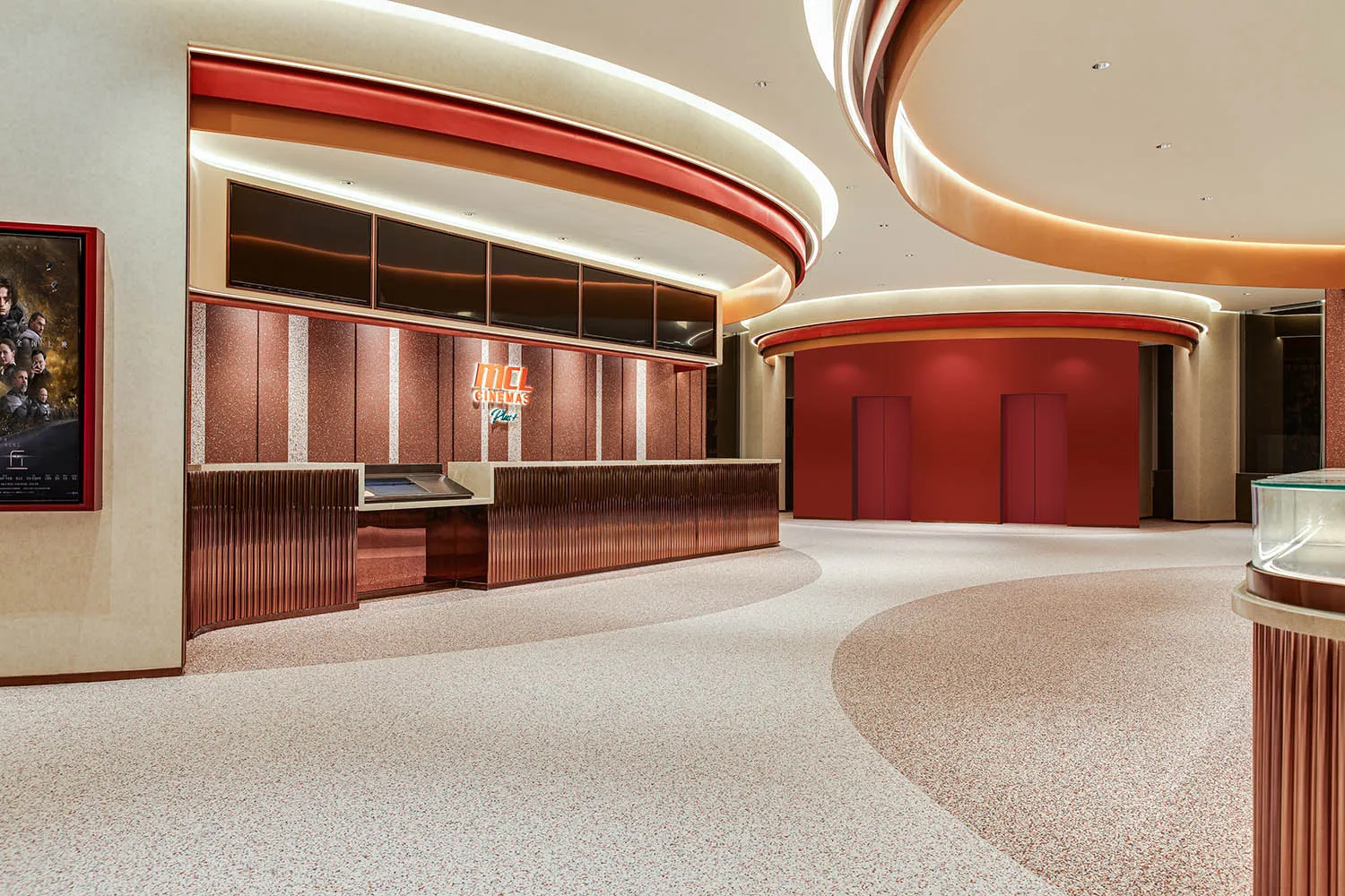 Image of a modern cinema hall interior with metallic texture walls and red accents.