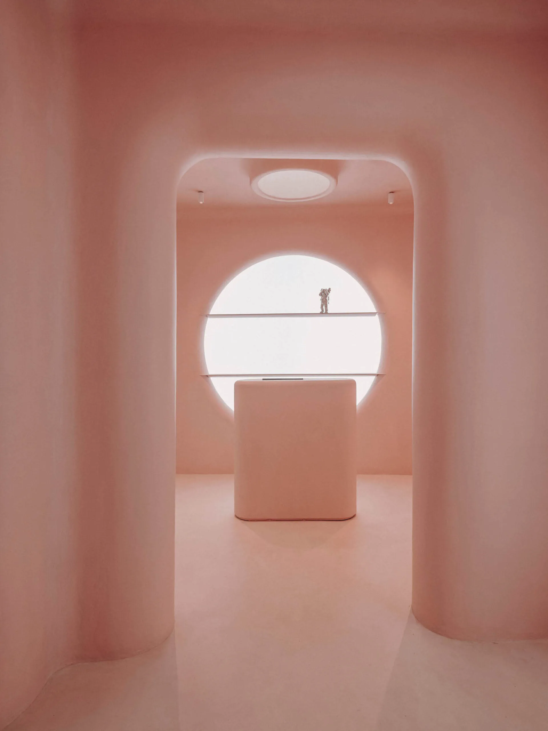Minimalist pink interior design with smooth pasted walls and circular window