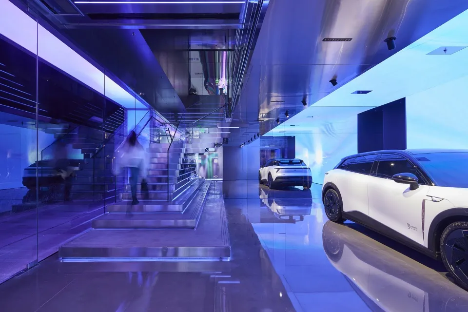 Automotive exhibition showcasing modern interiors with glass and metal materials.