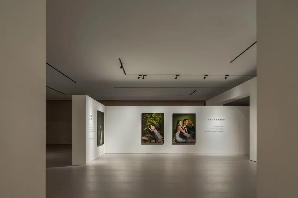 Photography exhibition in a modern space with white walls and minimalistic design.