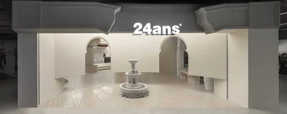 A minimalist retail display featuring concrete elements and architectural arches.