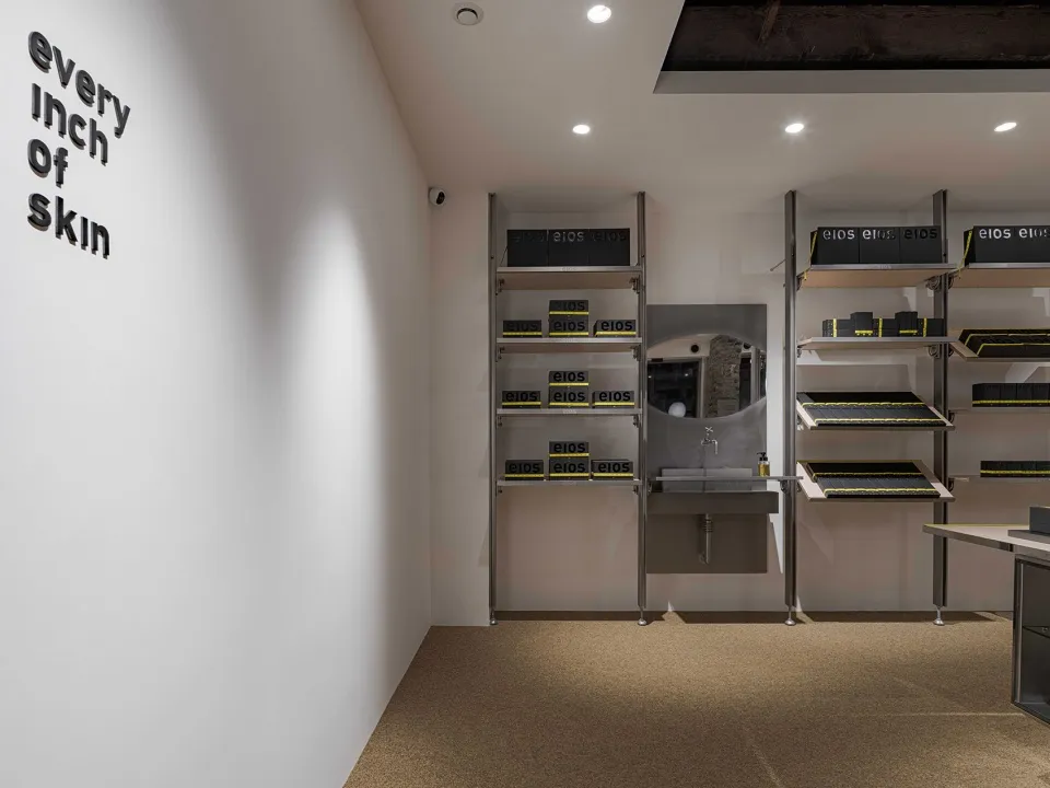 Retail store interior featuring metal shelves with black boxes