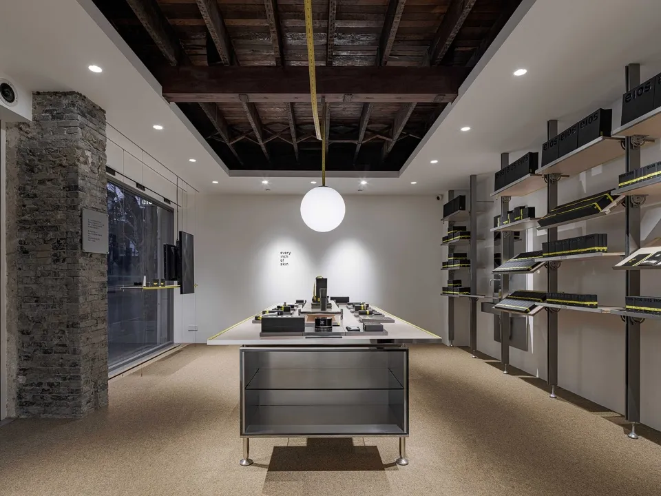A minimalist storefront with a concrete exterior and modern interior design features.