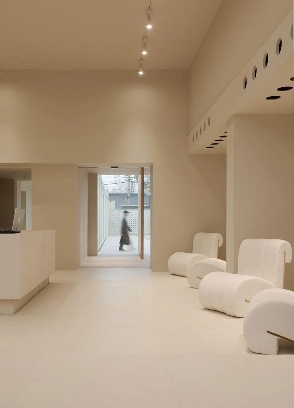 Modern reception area with light-colored terrazzo flooring and minimalist design.