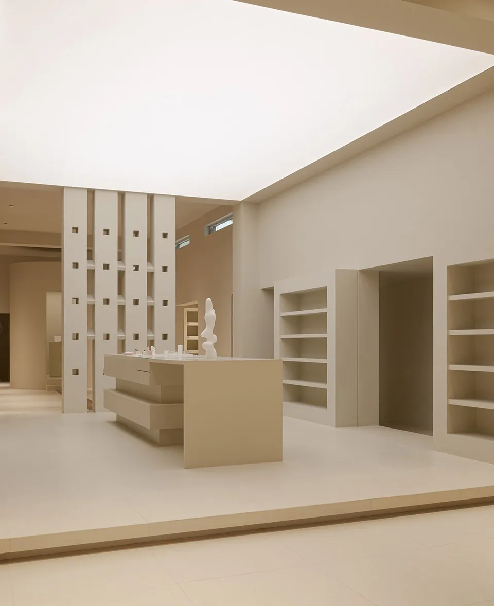 A clean, minimalist retail space with white Knoll furniture.