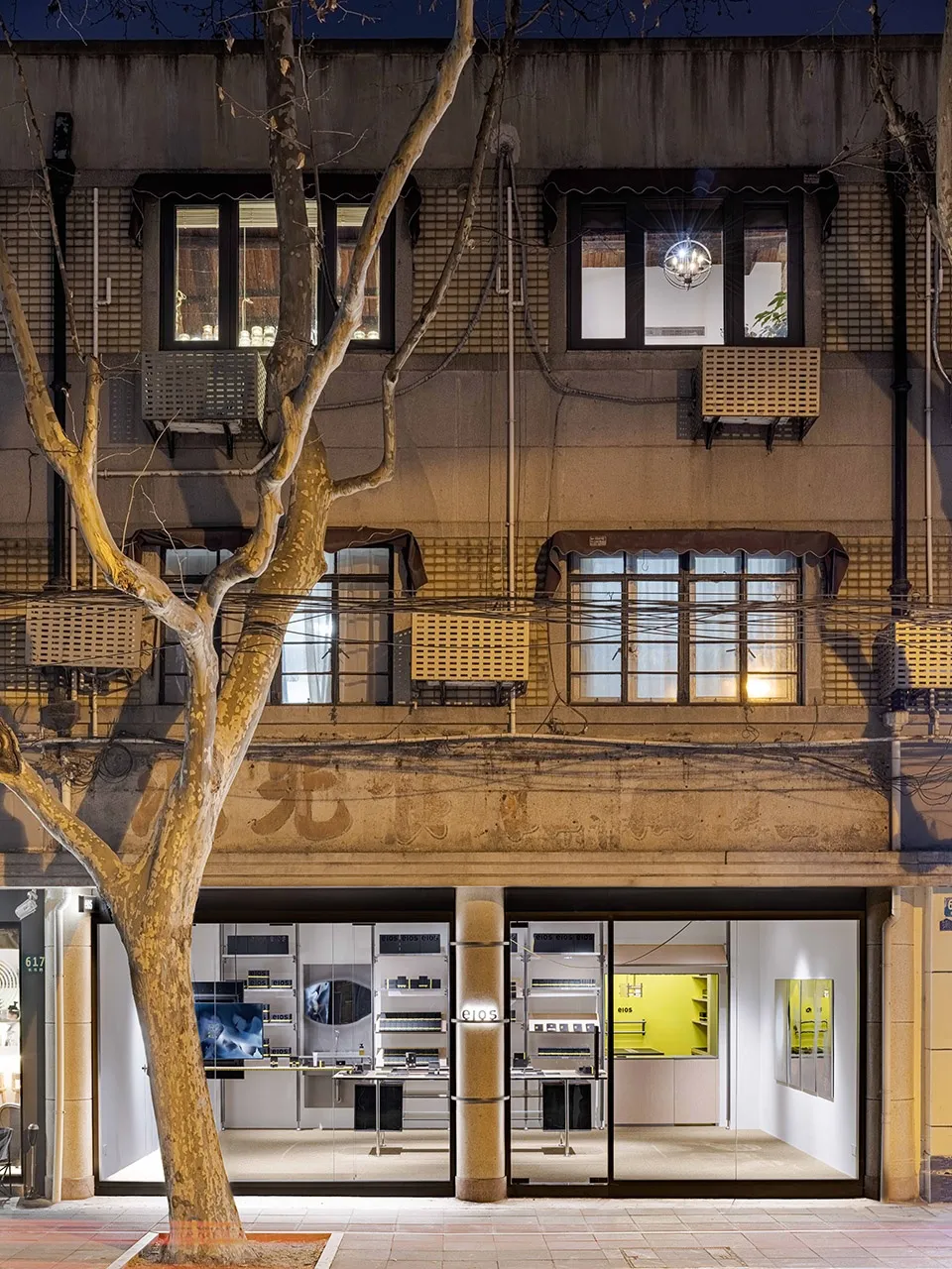 A modern commercial interior featuring glass, concrete, and steel materials.
