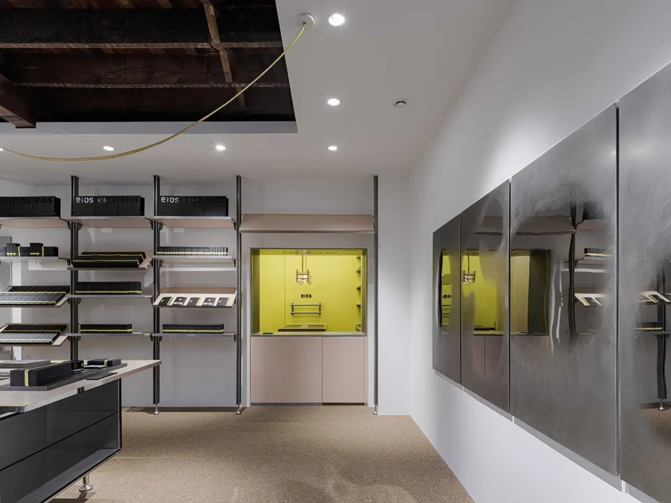 Modern storefront with black shelves, yellow accents, and metal cabinets.