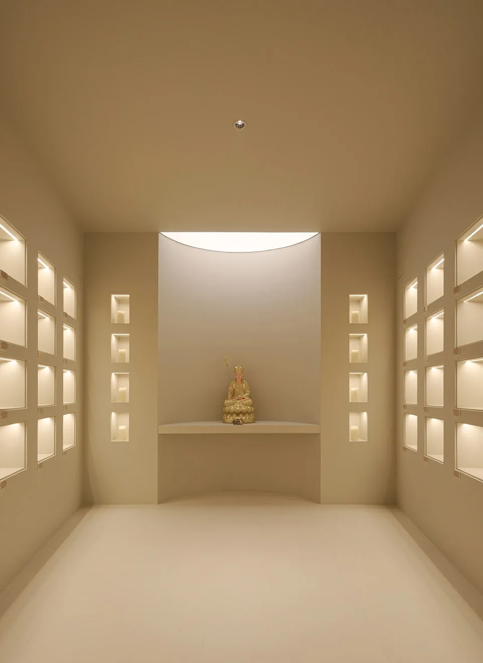 Minimalist interior with white walls and candles, creating a serene atmosphere.