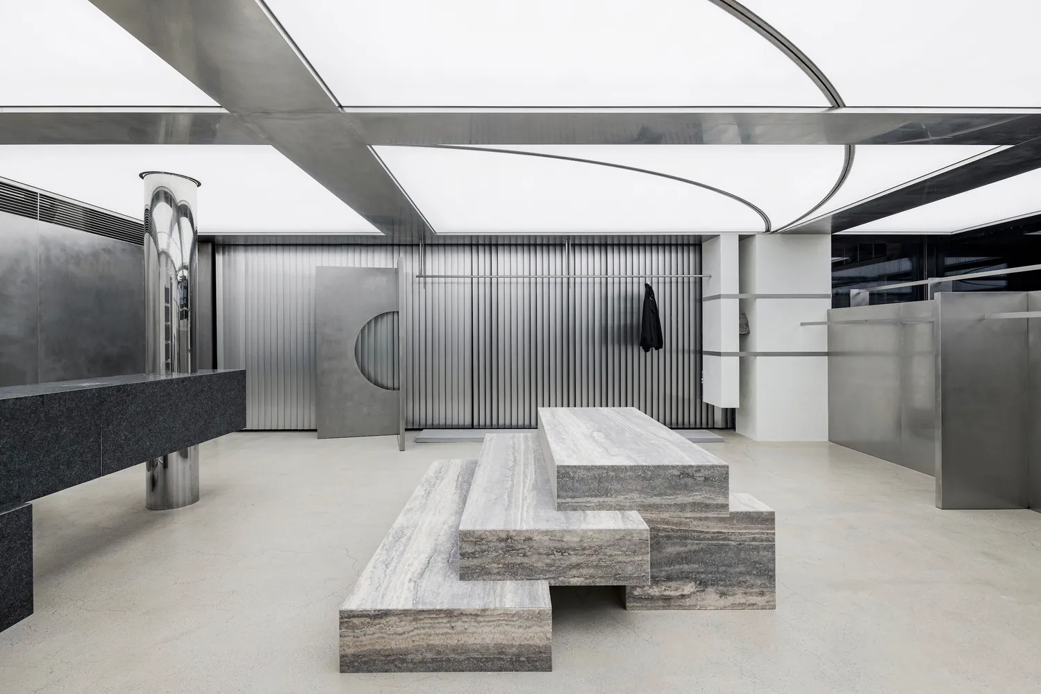 Industrial-style retail storefront with metal elements and concrete floor.