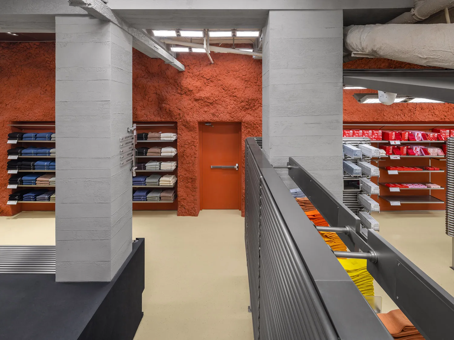 A retail store interior with concrete walls and floors.