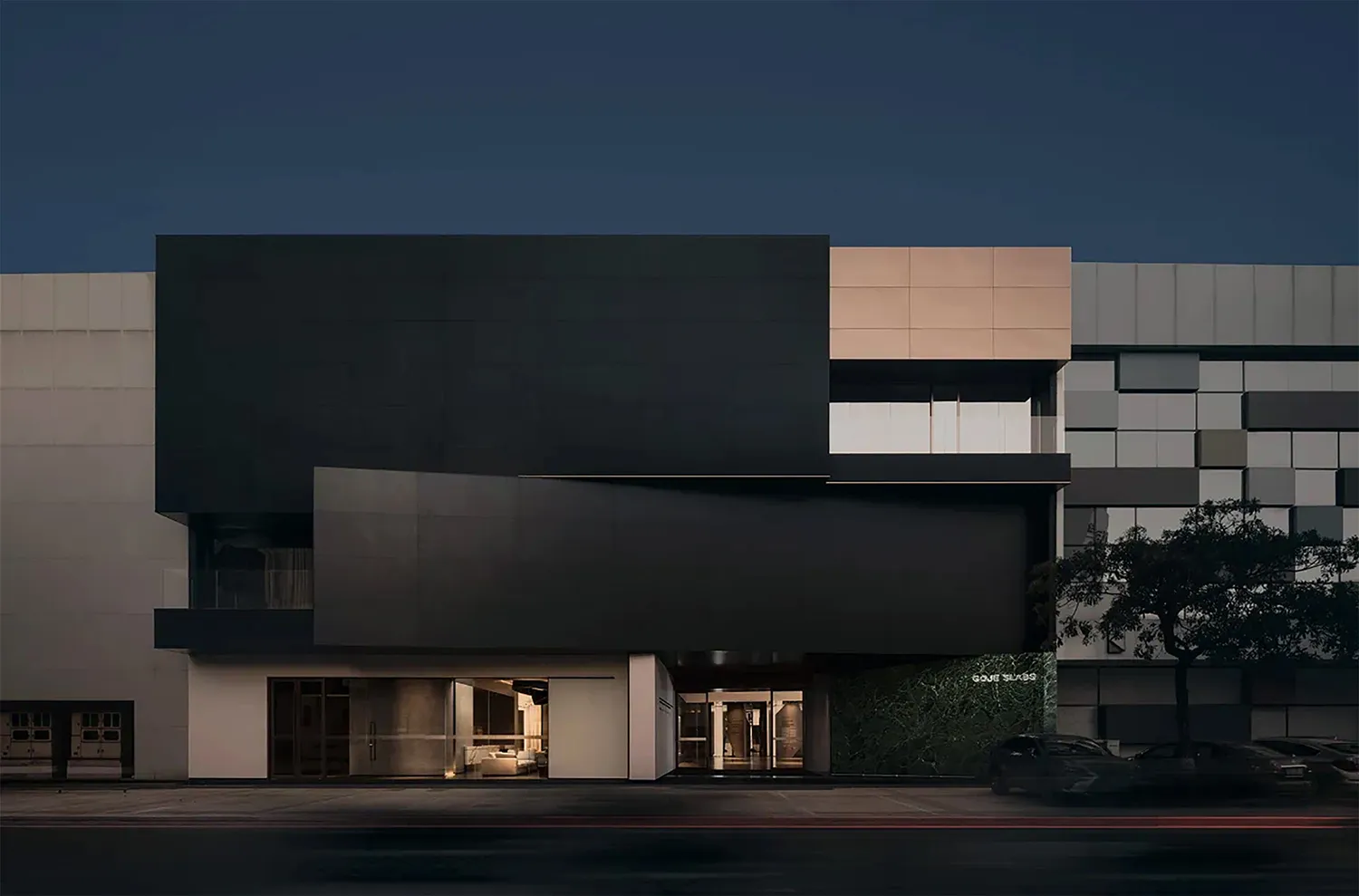 A modern retail space featuring glass and concrete materials on the exterior.
