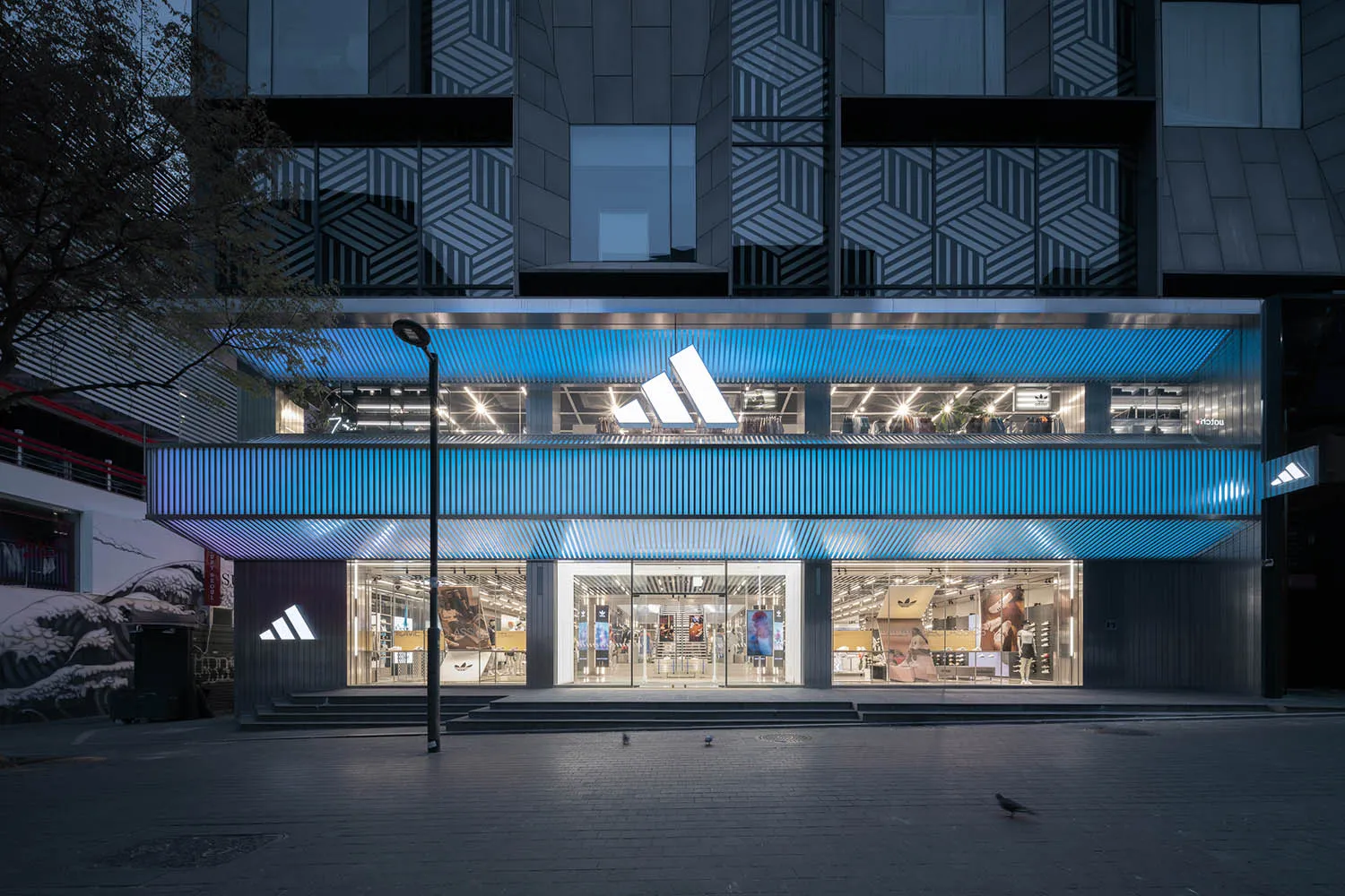 現代零售店面,玻璃牆面搭配鋁材點綴,夜晚以LED燈光照明。