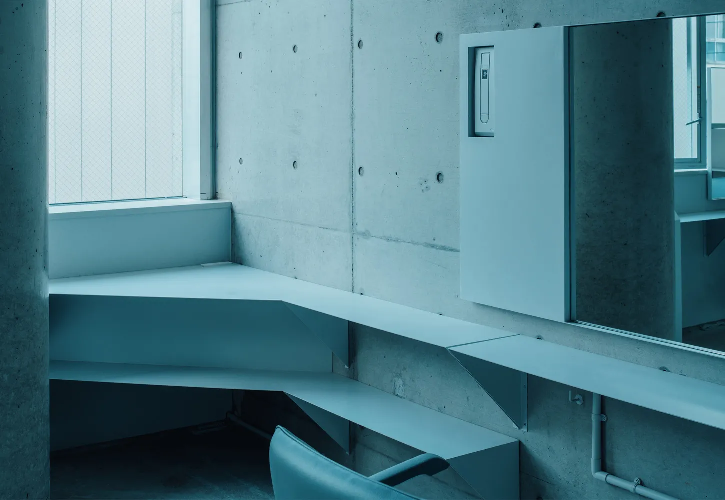 A modern industrial office space with concrete walls and minimalist design.