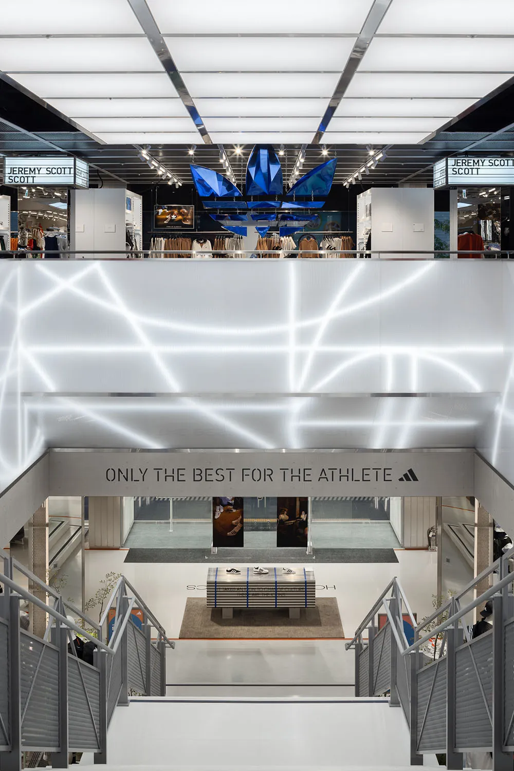 A modern retail storefront with blue acrylic shapes hanging from the ceiling.
