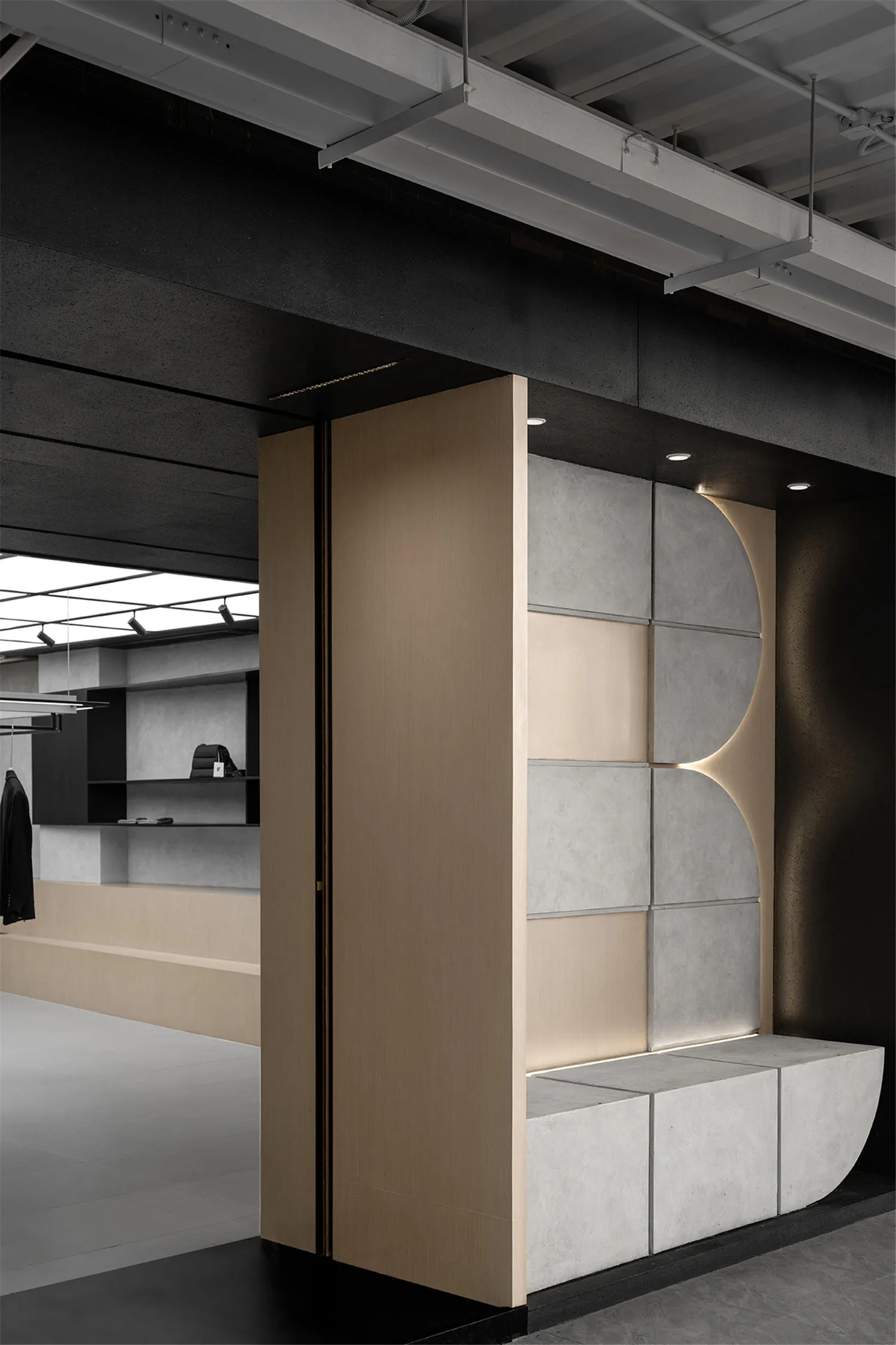 A modern commercial space with concrete and wood features, showcasing contemporary design elements.