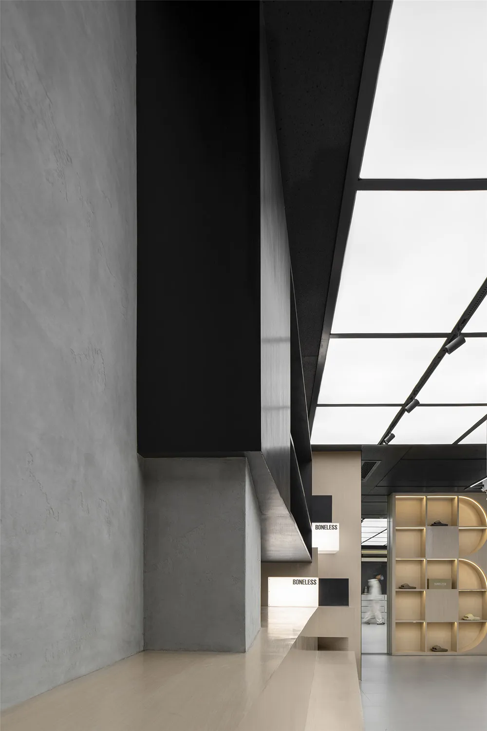 Modern indoor space featuring concrete walls and floor, with a minimalist design.