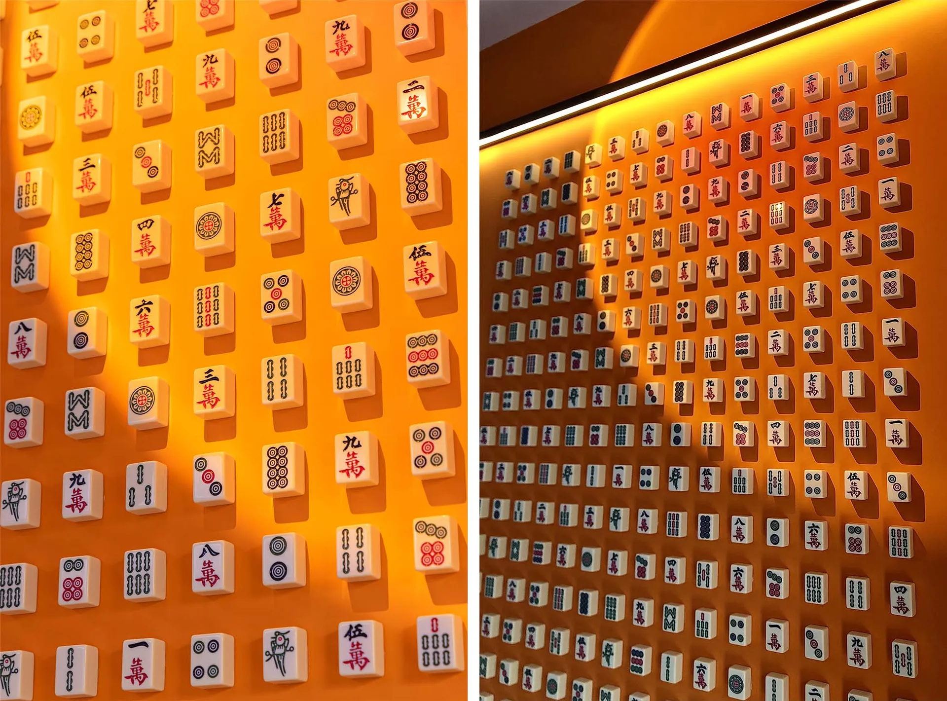 A wall adorned with patterned ceramic tiles featuring symbols and characters associated with the game of Mahjong.