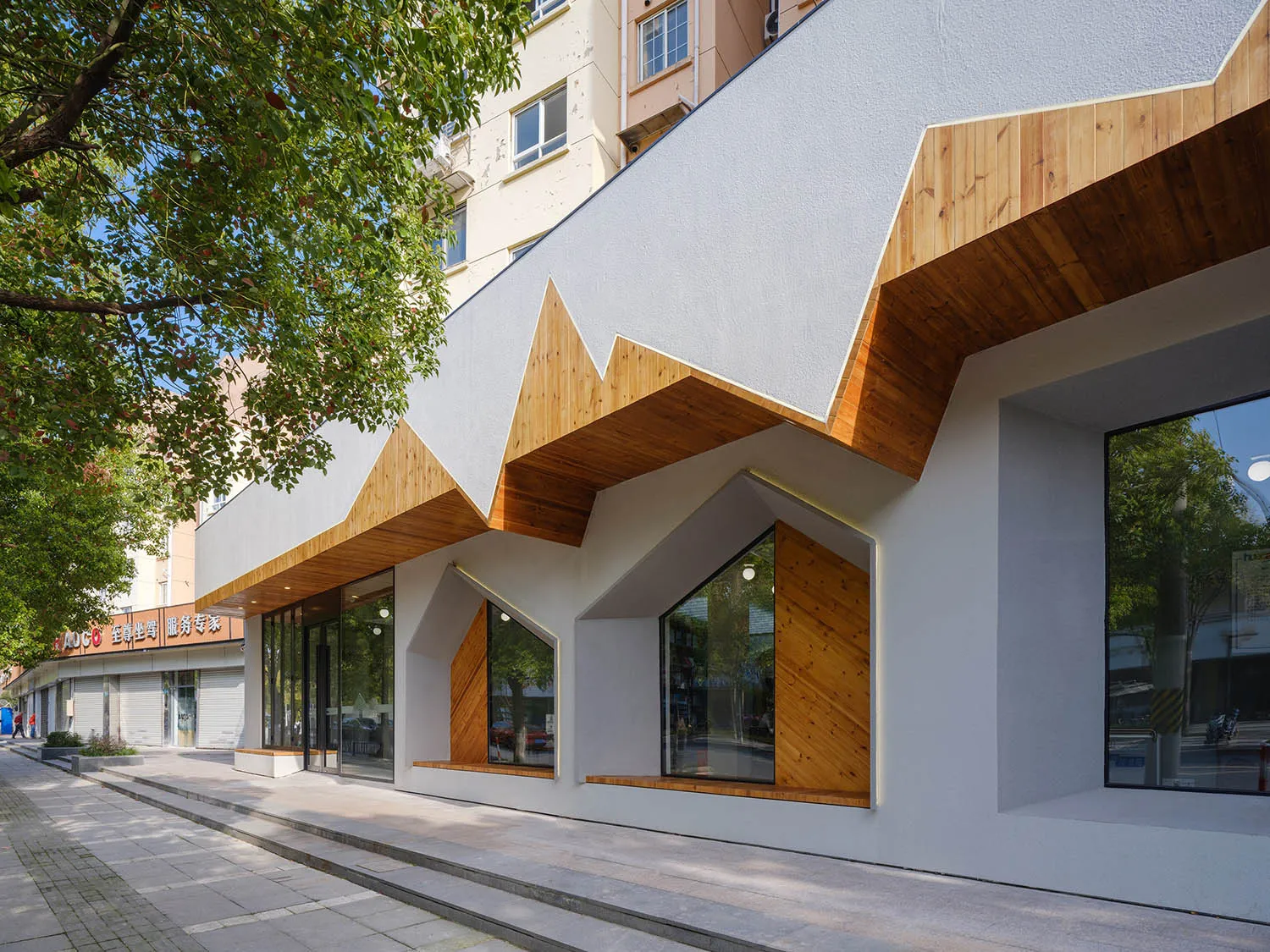 A modern storefront with a combination of wood and concrete materials.