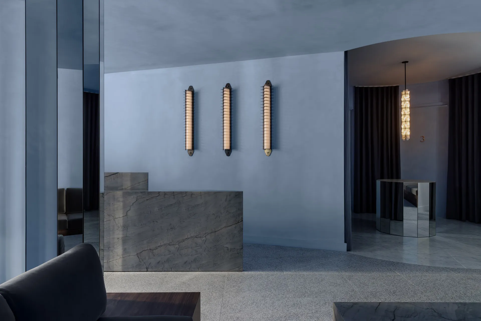 Modern hotel lobby featuring marble finishes and minimalist design.