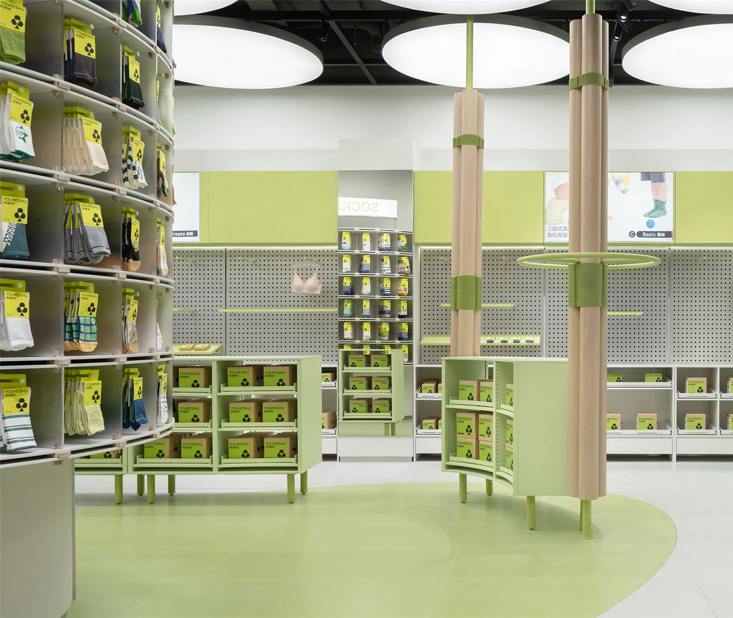 A modern retail store section showcasing green painted wooden shelves and display units.