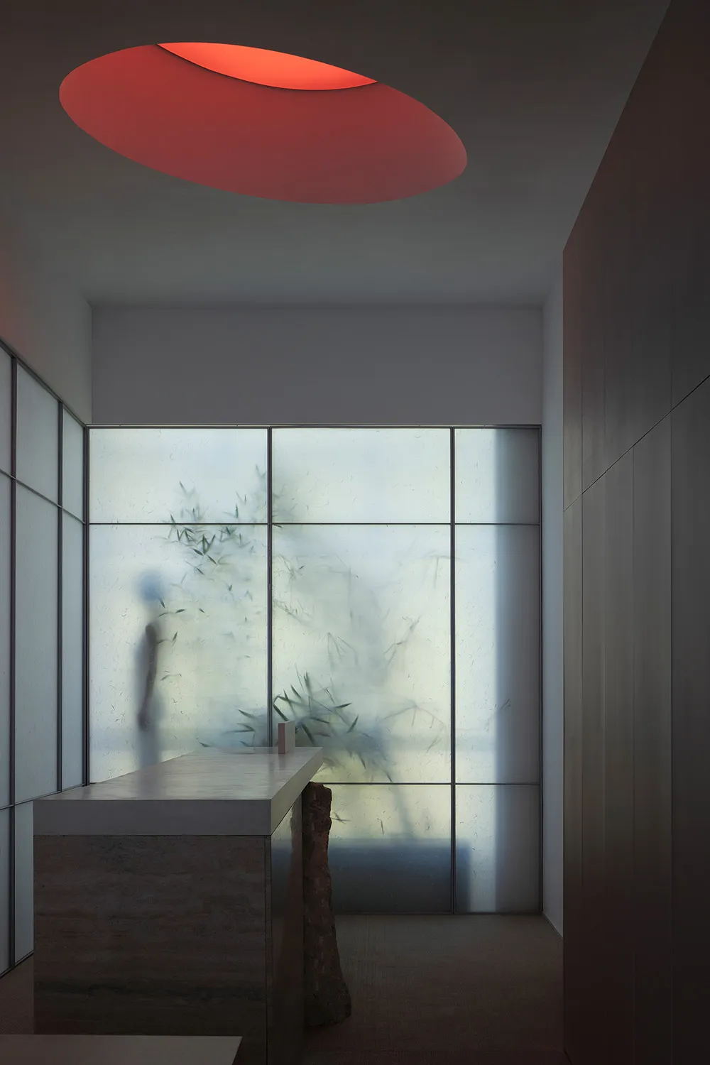 A minimalist interior design featuring a glass curtain wall, showcasing contemporary design elements.