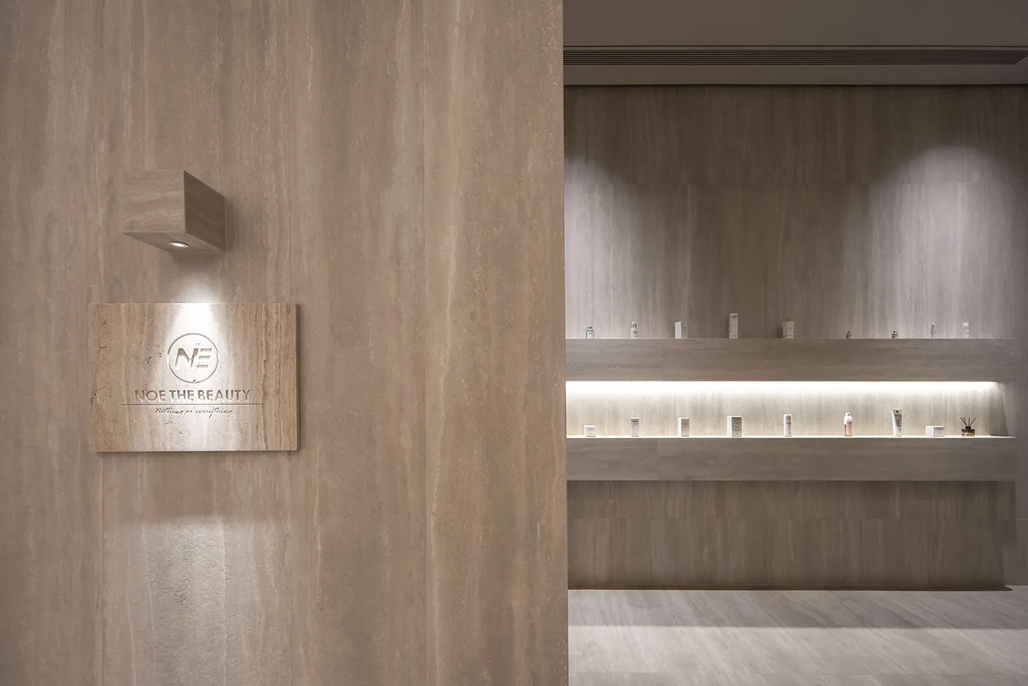A minimalistic retail shop featuring concrete interiors and signage.