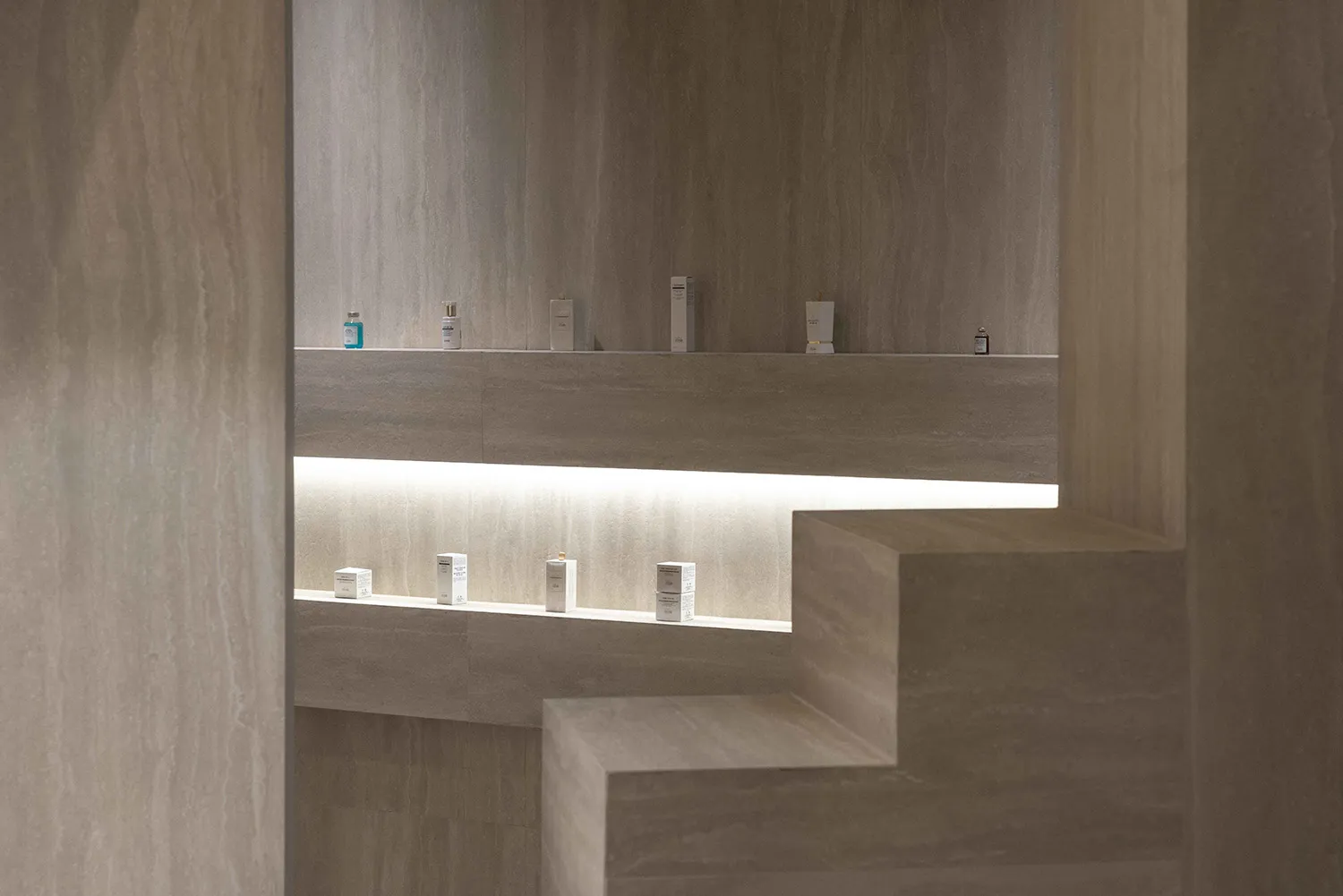 Modern minimalist retail store interior with concrete walls and glass displays.