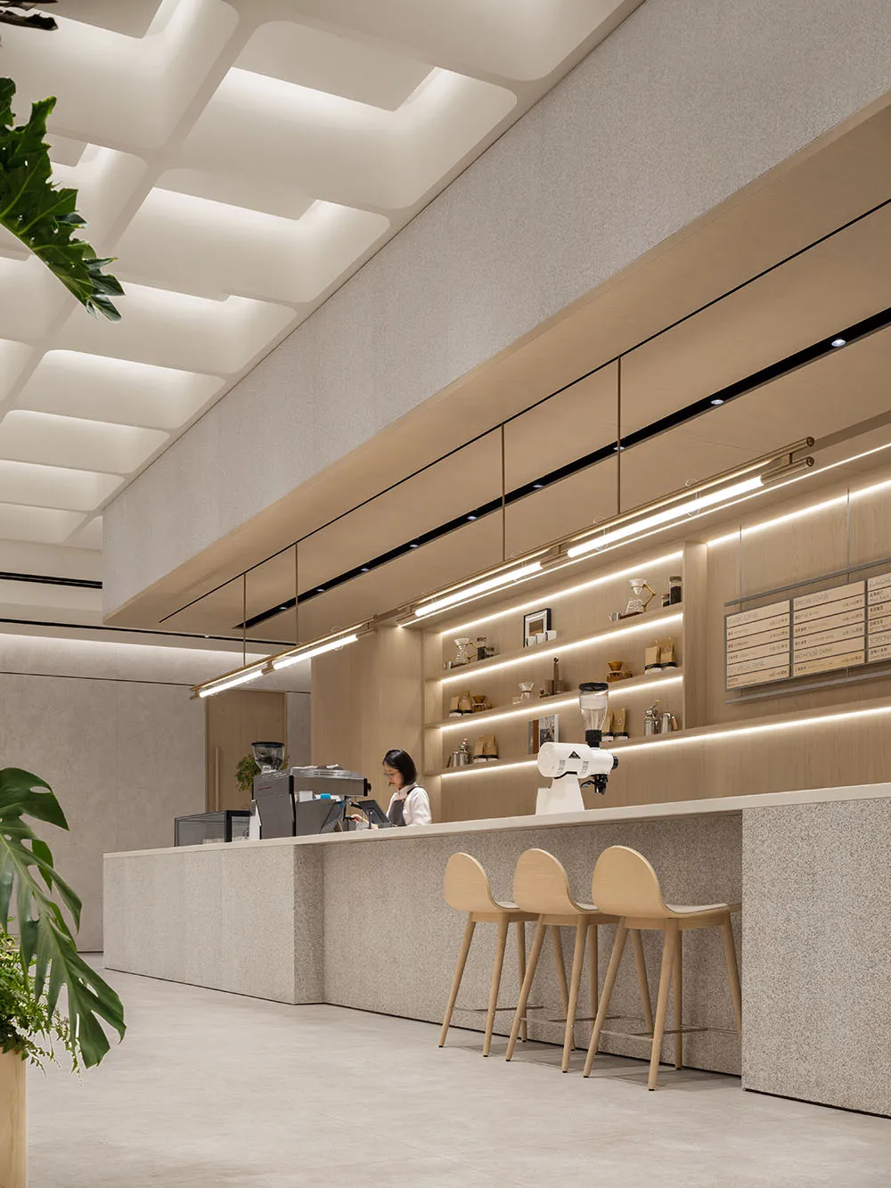 Interior design of a modern coffee shop featuring natural wood materials.
