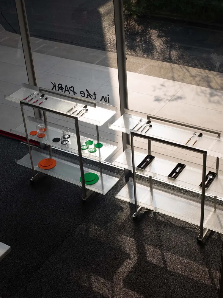 Glass-paneled metal rack displayed in a storefront window.