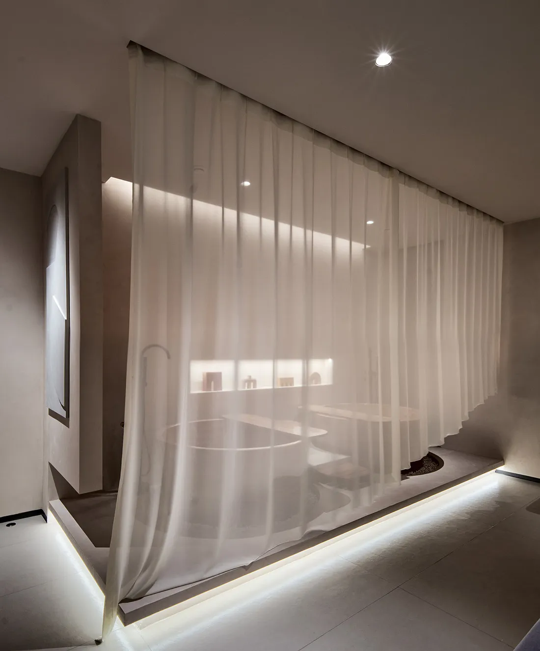 Modern bathroom interior featuring transparent curtains and minimalist design.