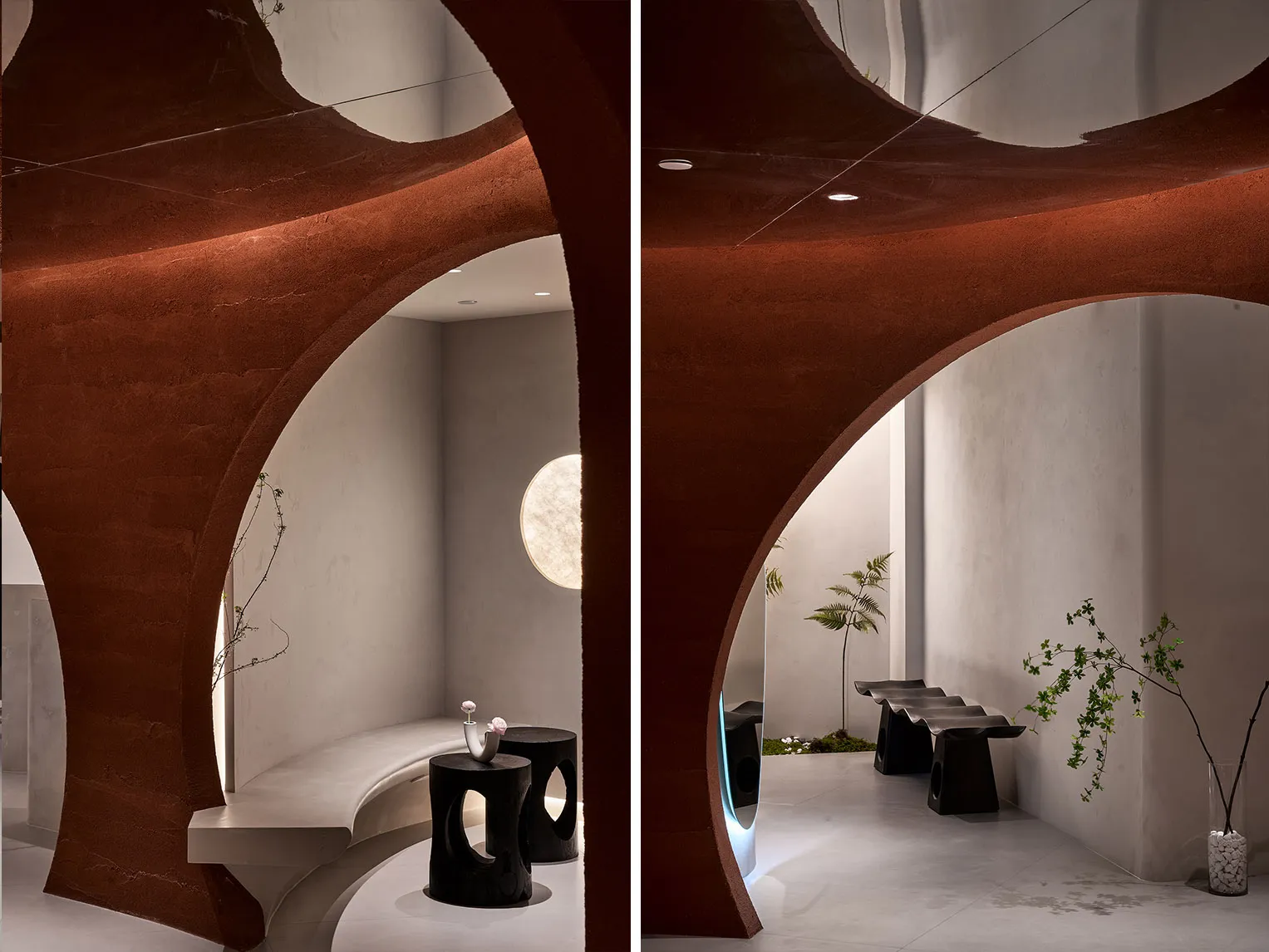 A minimalist interior space with modern concrete walls, a curved design, and a geometric lighting fixture