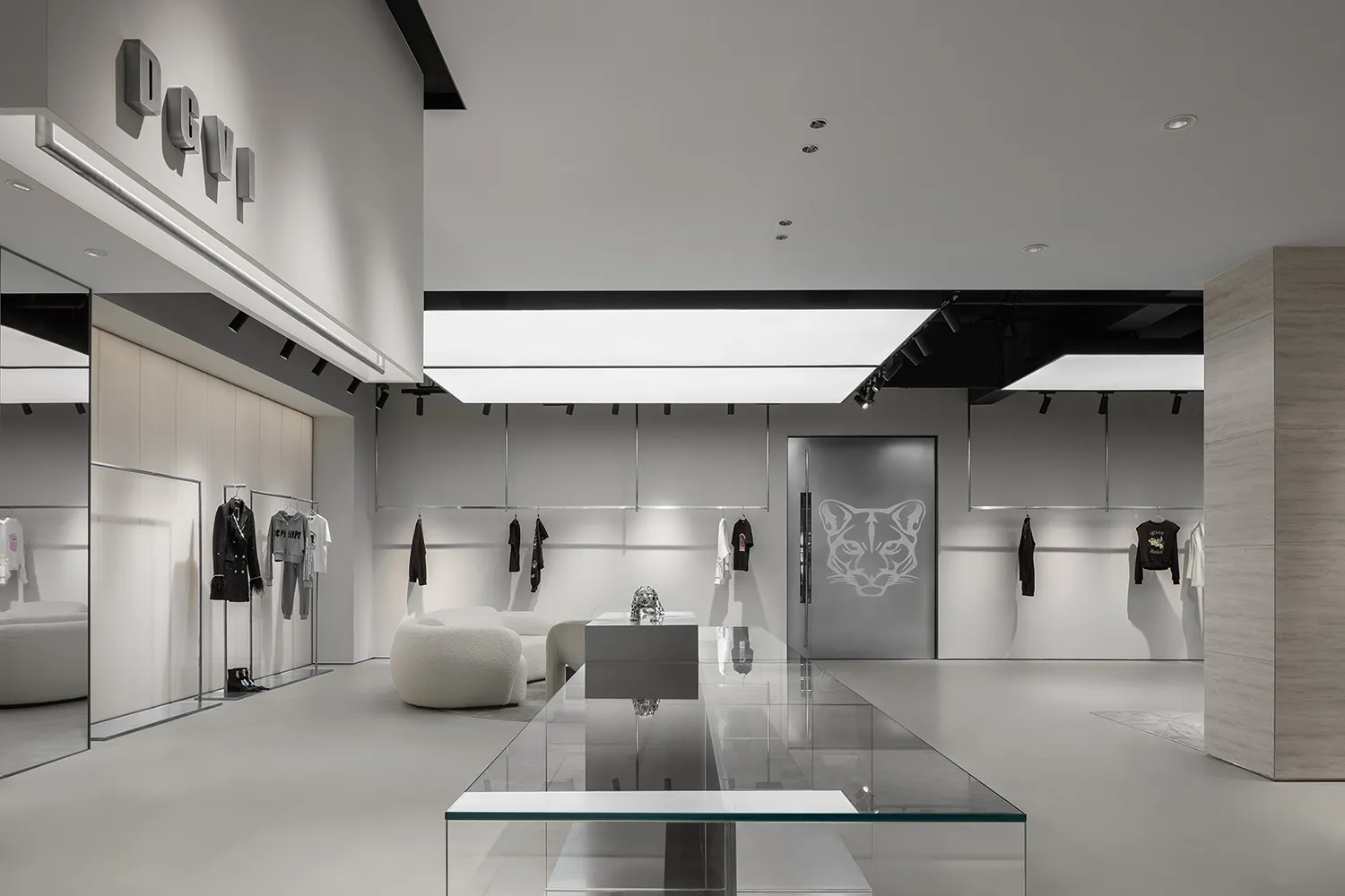 Modern minimalist retail storefront with white walls, floors, and furniture, featuring neutral tones and sleek design element