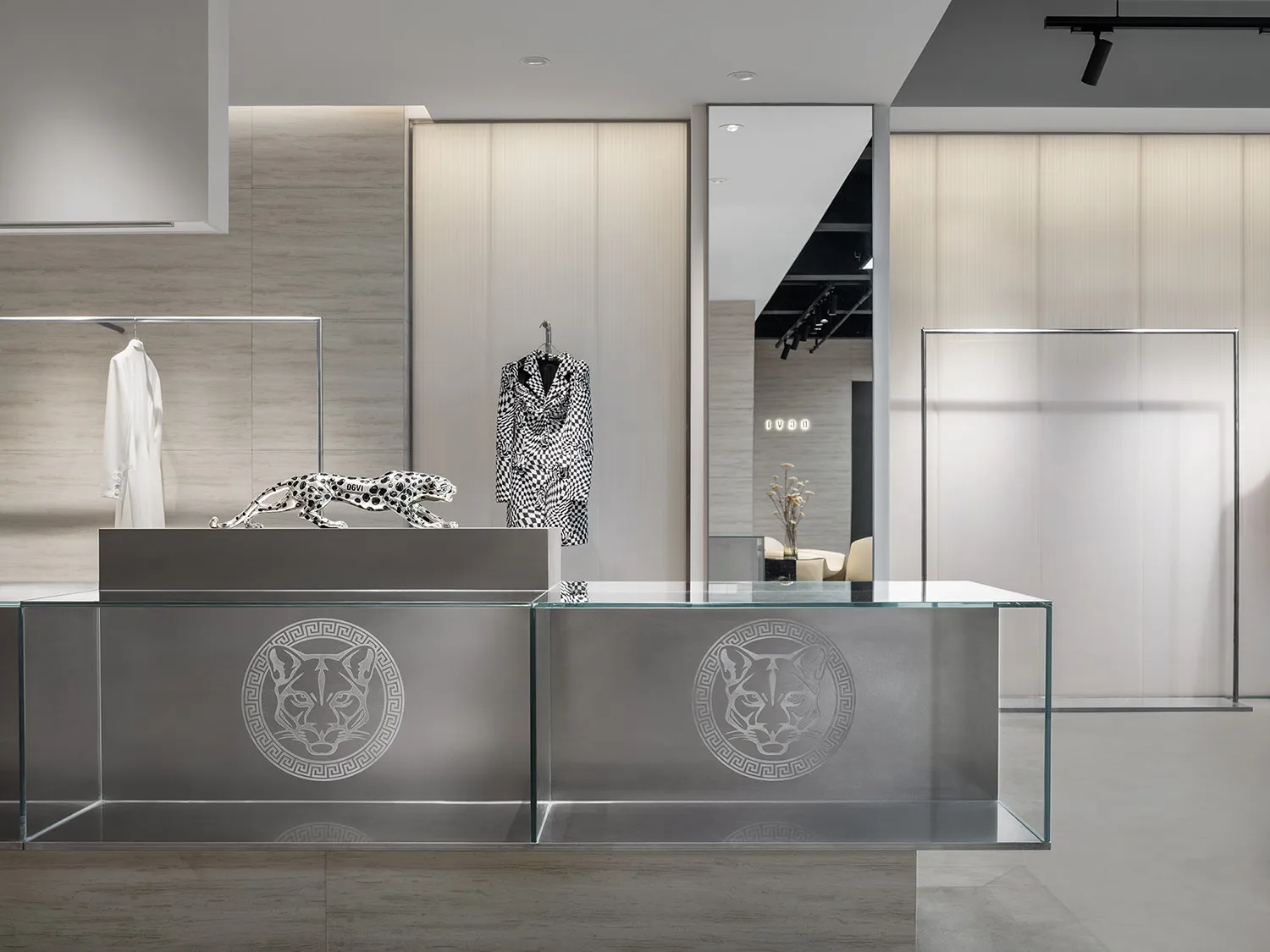 A modern retail storefront featuring a sleek glass counter with a jaguar logo.