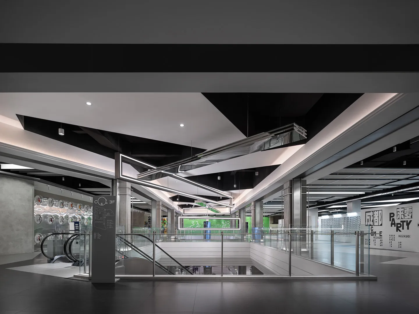 Shopping center interior featuring modern design with glass, metal, and concrete materials.