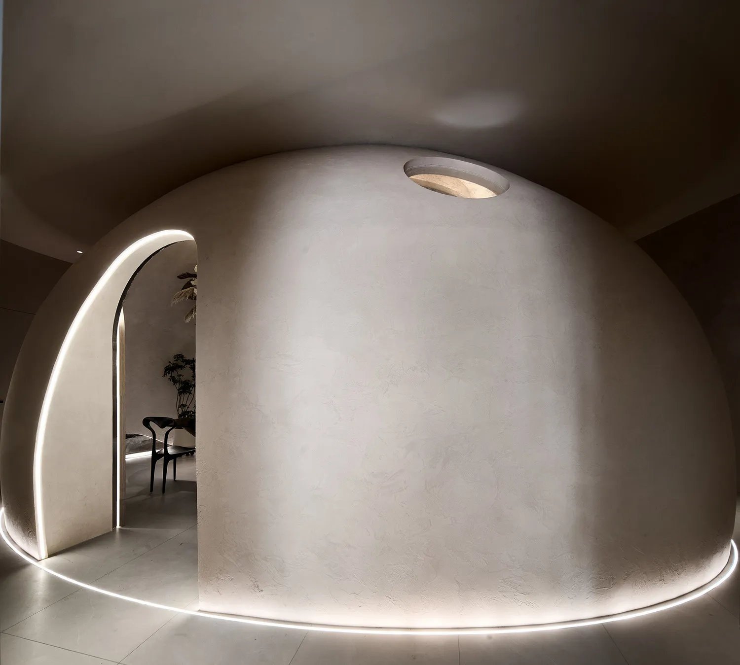 A modern living room with a concrete wall and floor, featuring minimalistic design elements.