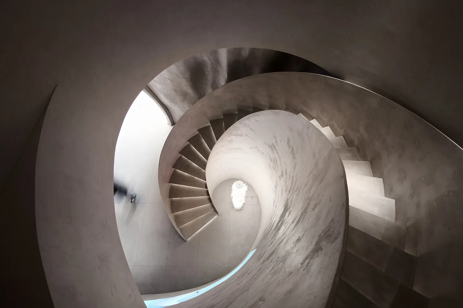 A modern concrete staircase with curved steps.