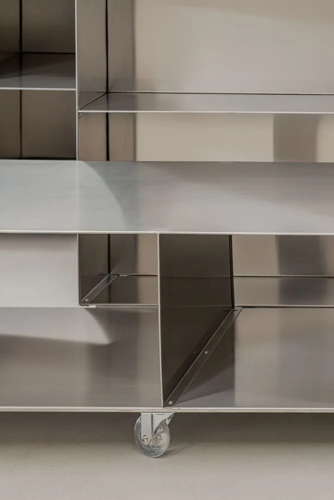 Clean-lined, metal shelving unit with wheels.