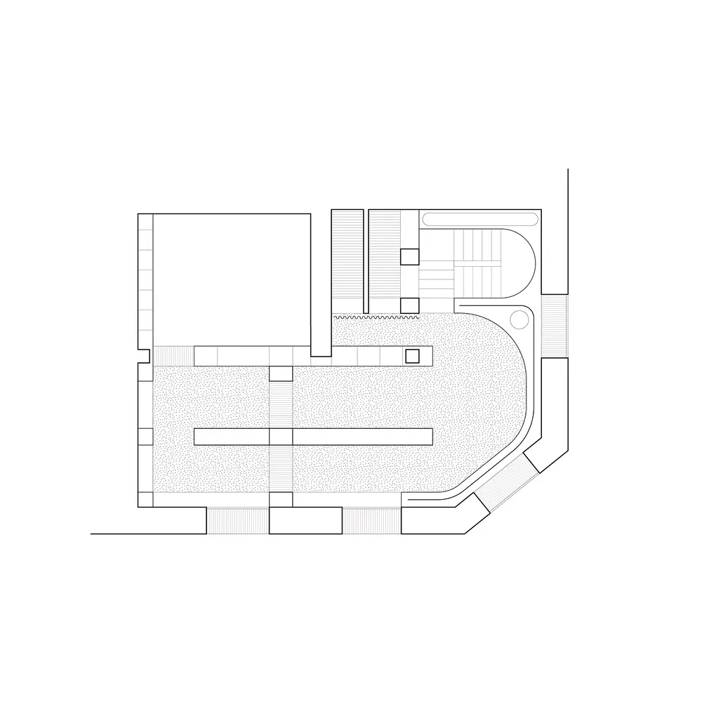 A black and white architectural drawing of an interior space featuring concrete steps and a staircase.