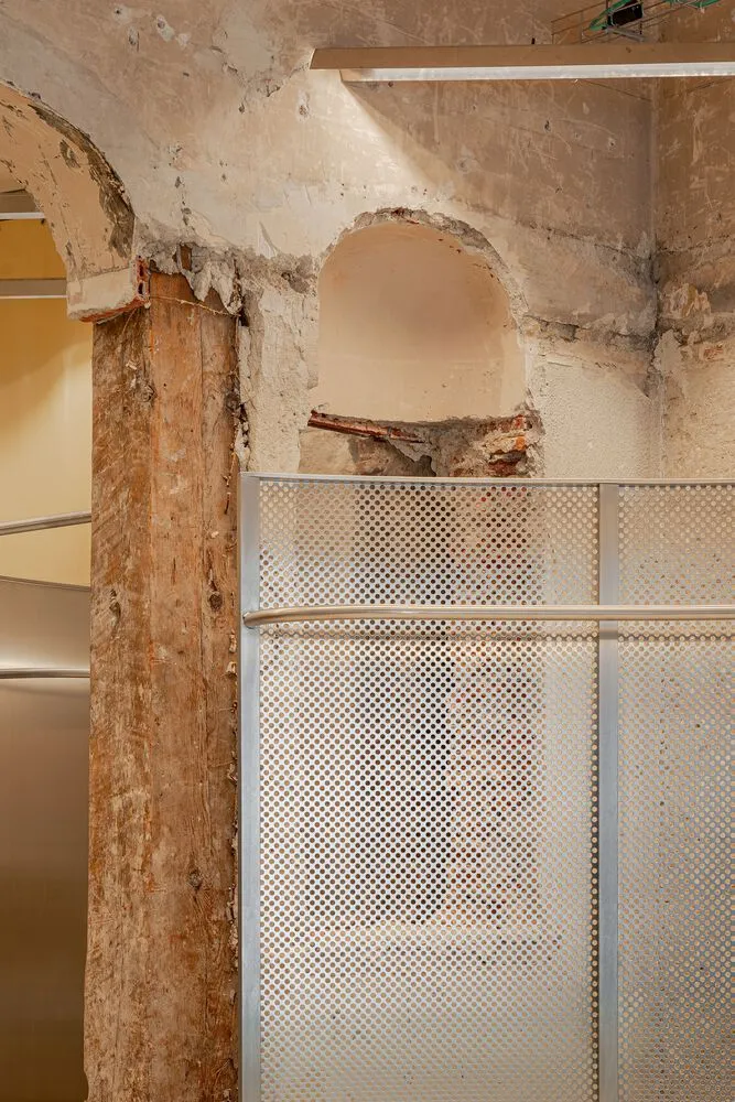 Construction repair of a wall with metal and concrete materials.